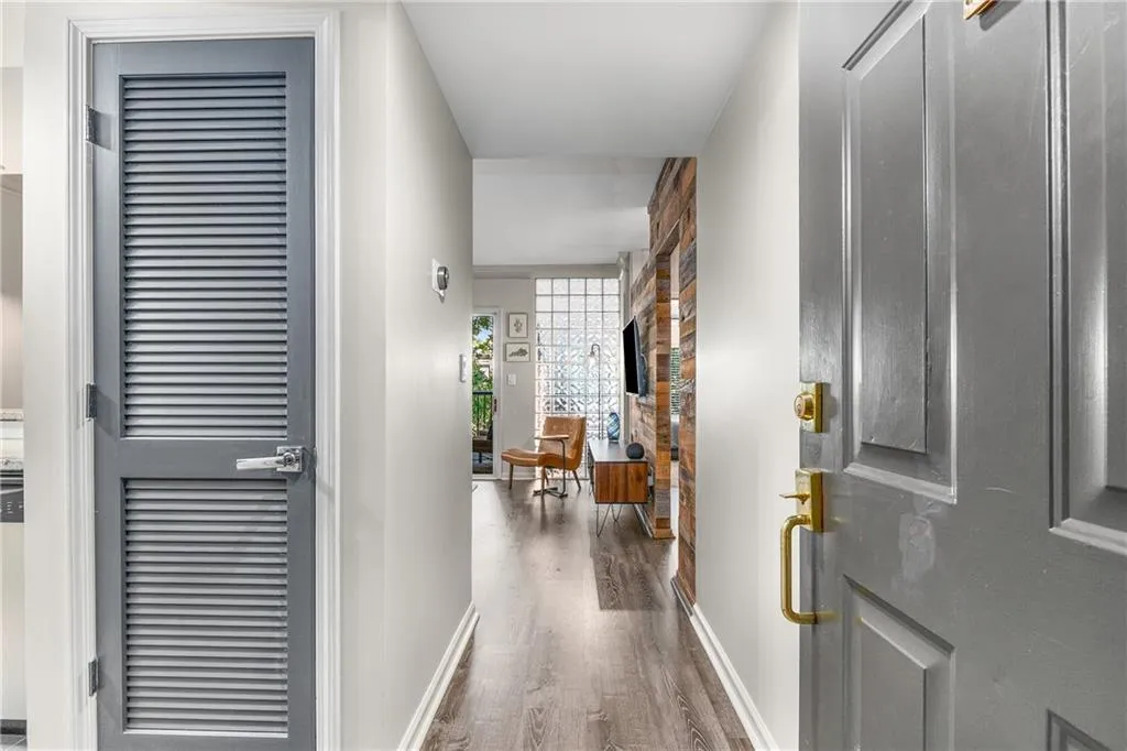 Entryway featuring dark wood-style floors and baseboards