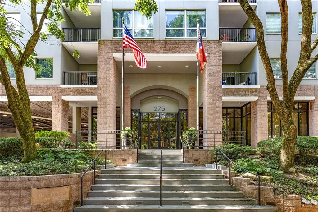Property entrance featuring stucco siding and french doors
