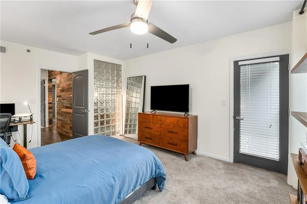 Bedroom featuring light carpet and ceiling fan
