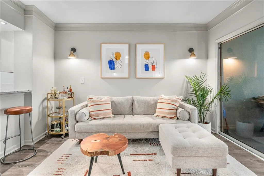 Living area featuring crown molding and wood finished floors