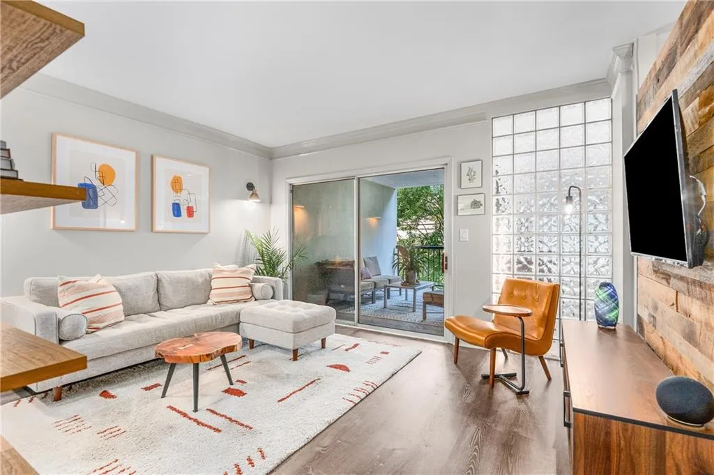Living room featuring ornamental molding and wood finished floors