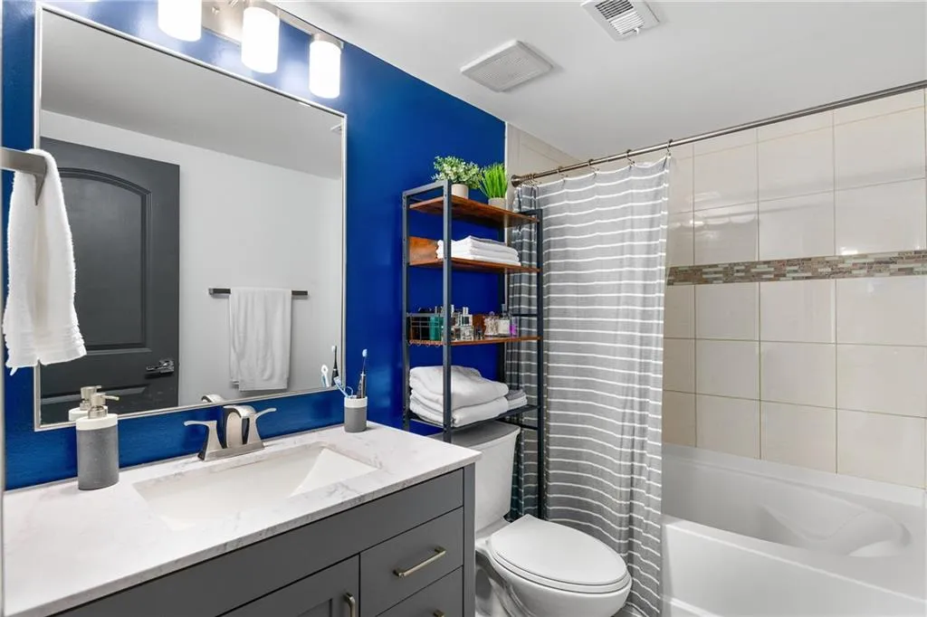Full bathroom featuring shower / tub combo and vanity