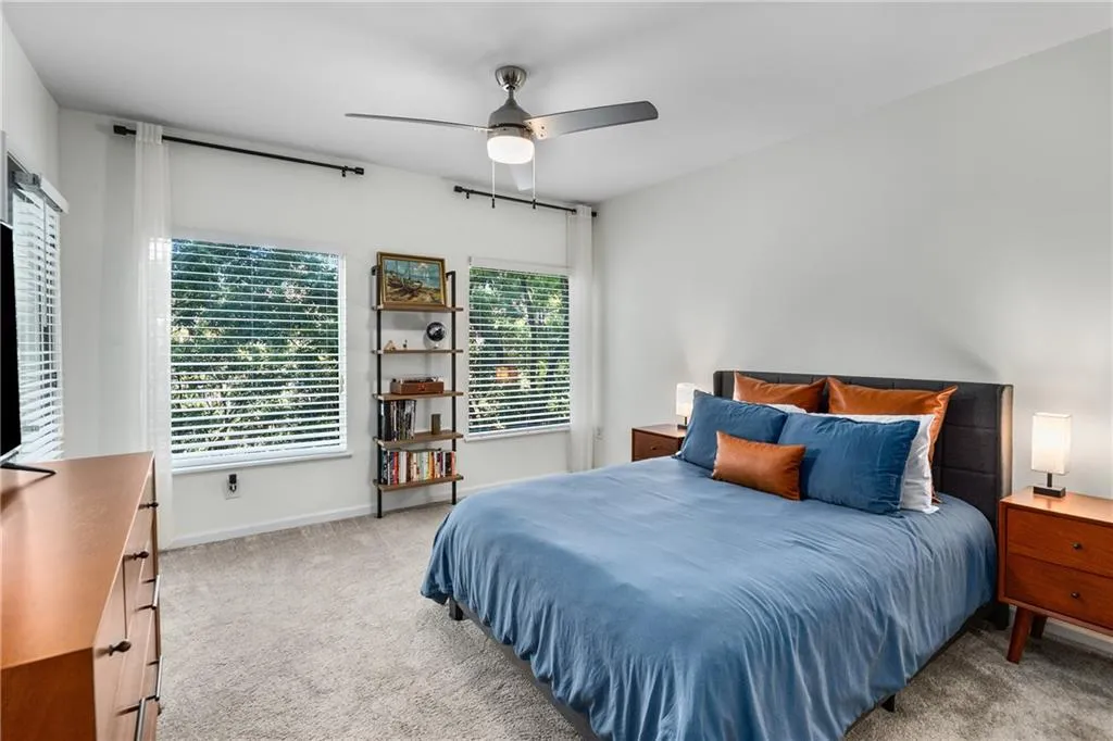 Bedroom featuring light carpet and ceiling fan