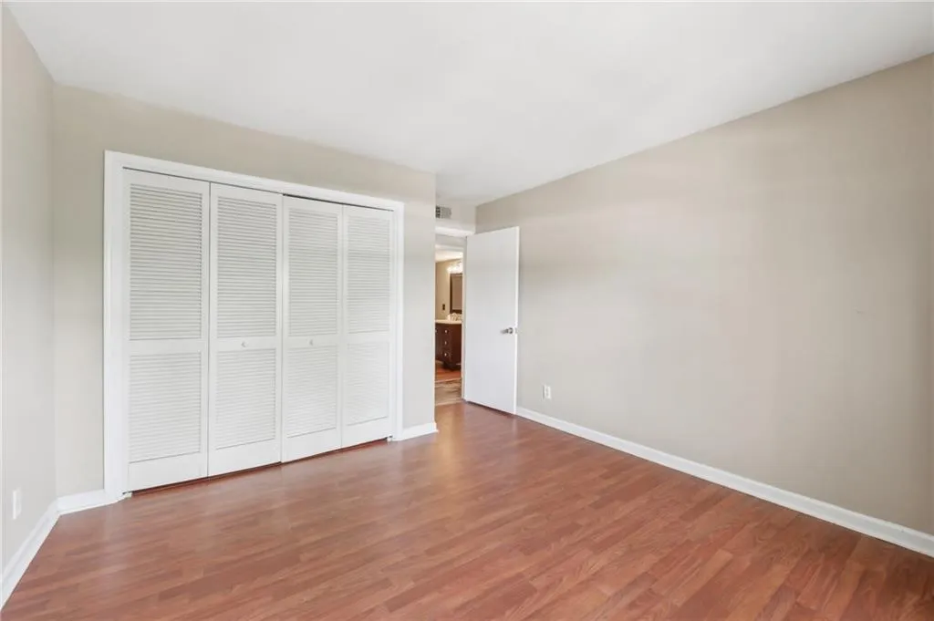 Unfurnished bedroom featuring wood finished floors and a closet
