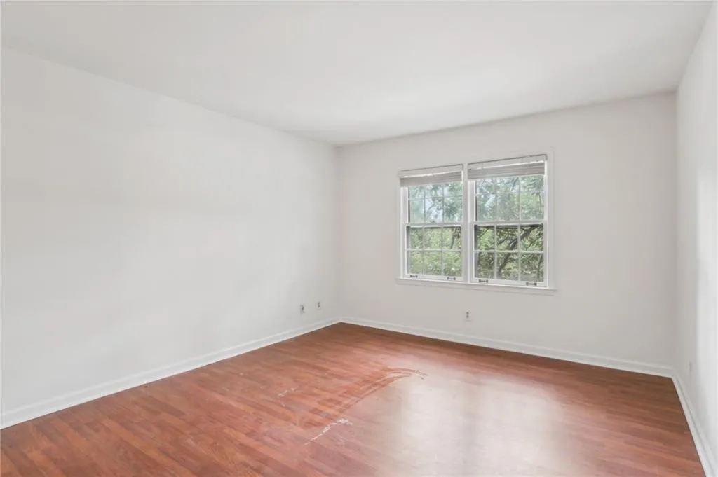 Spare room featuring wood finished floors