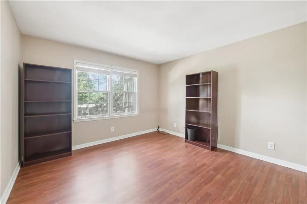 Empty room with wood finished floors and baseboards