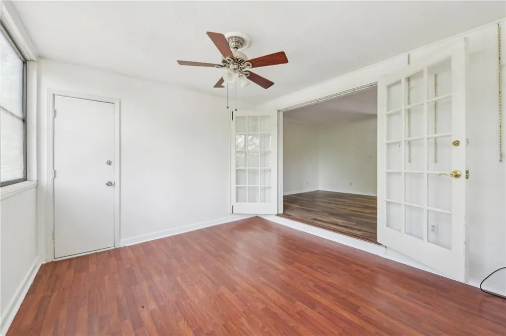Empty room with ceiling fan and wood finished floors