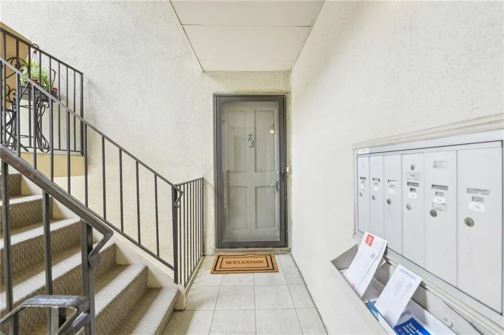 Doorway to property with stucco siding