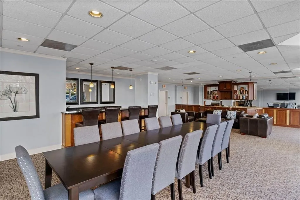 Dining room with recessed lighting, light carpet, and crown molding