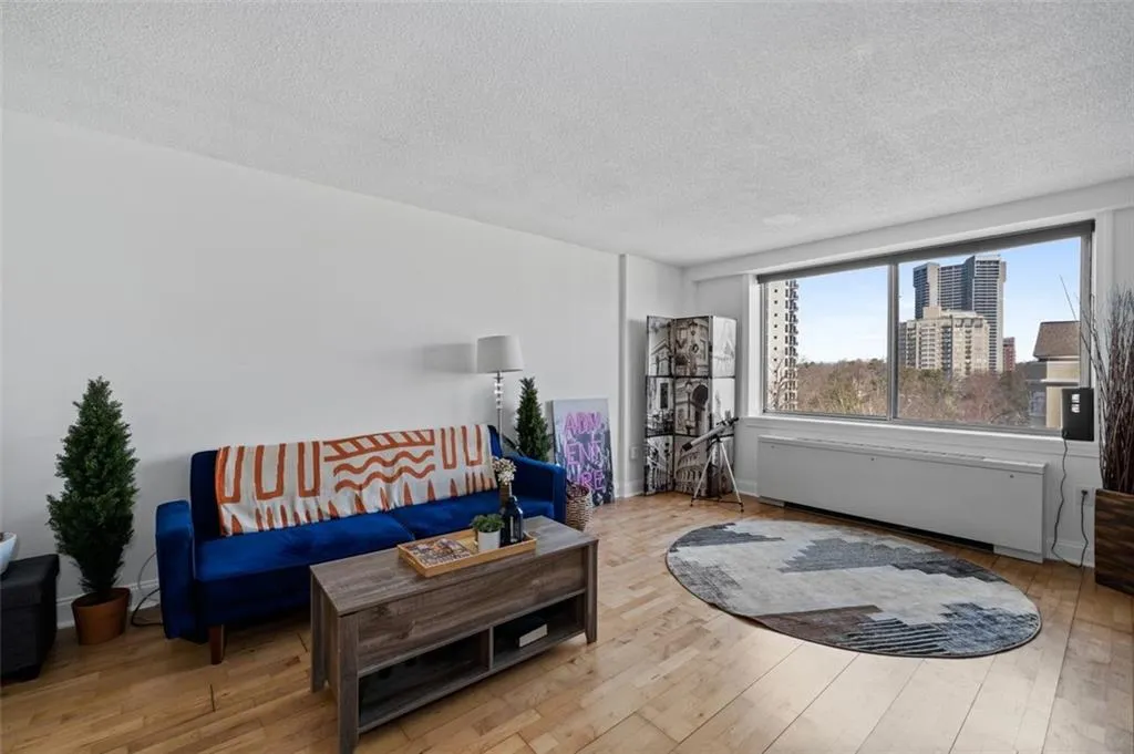 Living room with a city view, hardwood / wood-style flooring, and a textured ceiling