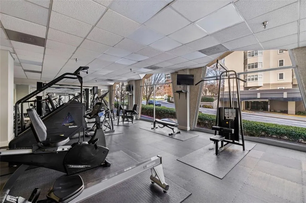 Exercise room featuring a wall of windows and a paneled ceiling