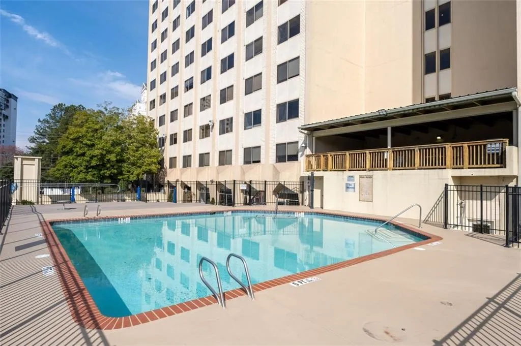 Pool featuring a patio area and fence