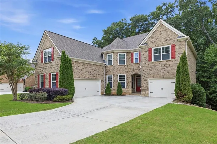 Three-sided brick with a 3-car garage