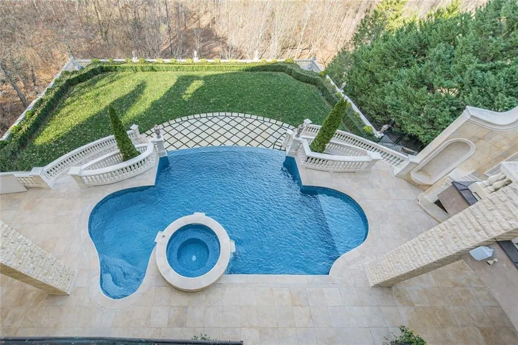 View of swimming pool with a patio area and a pool with connected hot tub