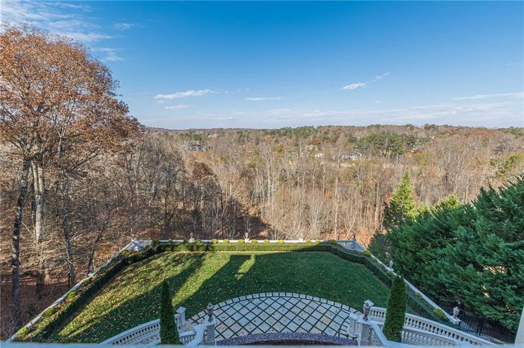View of grassy yard featuring a forest view