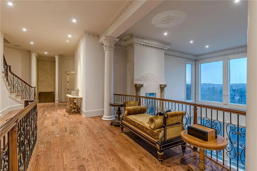 Living area with recessed lighting, light wood-style flooring, crown molding, and stairs