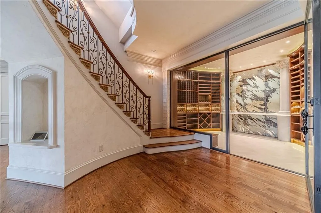 Wine room with wood finished floors and crown molding