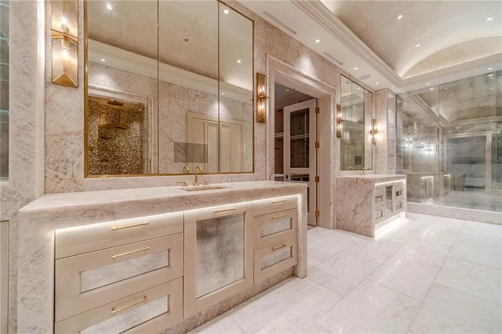Bathroom featuring crown molding, light marble finish flooring, recessed lighting, vanity, and a shower stall