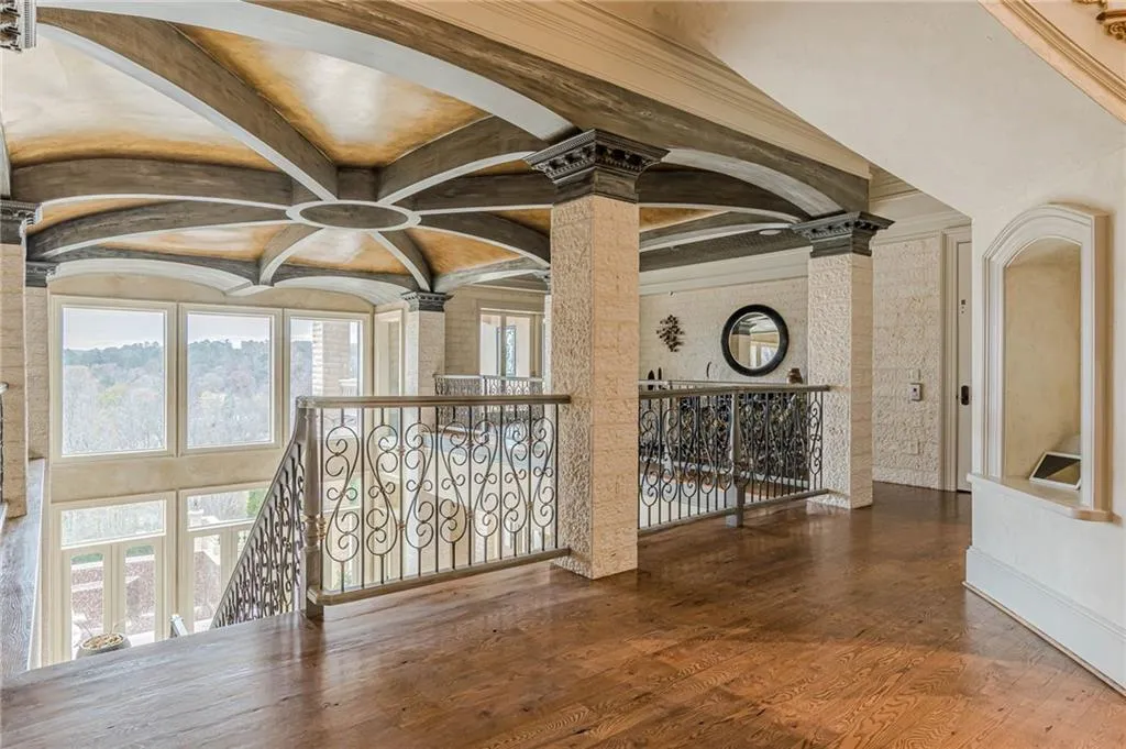Hall featuring an upstairs landing and hardwood / wood-style flooring
