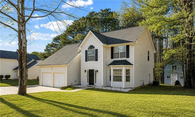 Two-story residence featuring white siding and a dark shingled roof