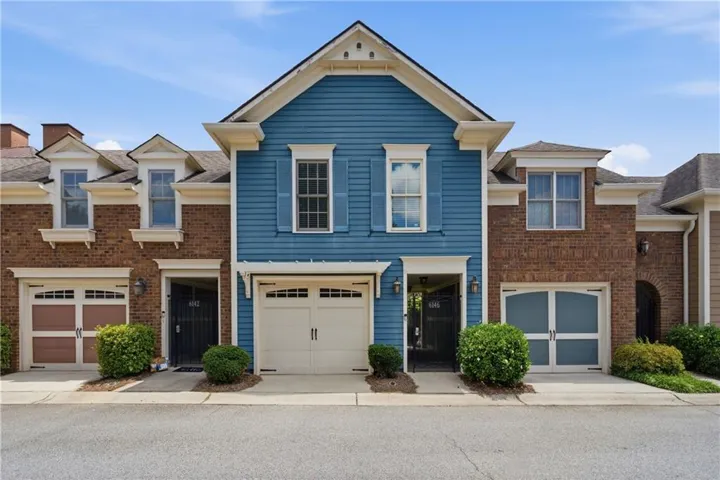Blue siding and brick facade with white trim accents