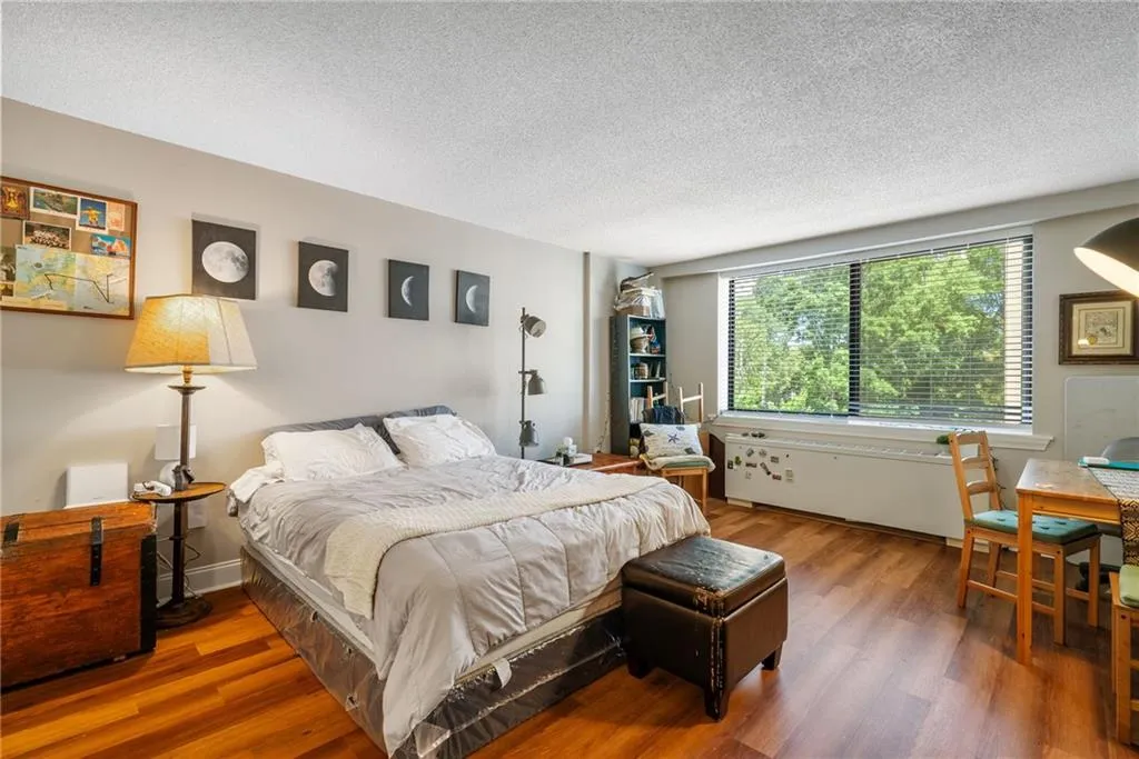 Bedroom featuring a textured ceiling and hardwood / wood-style floors