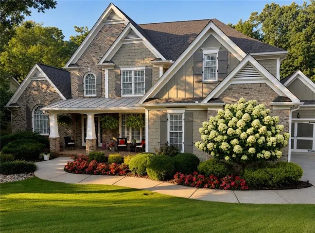Traditional-style residence featuring a brick and siding facade with gabled rooflines