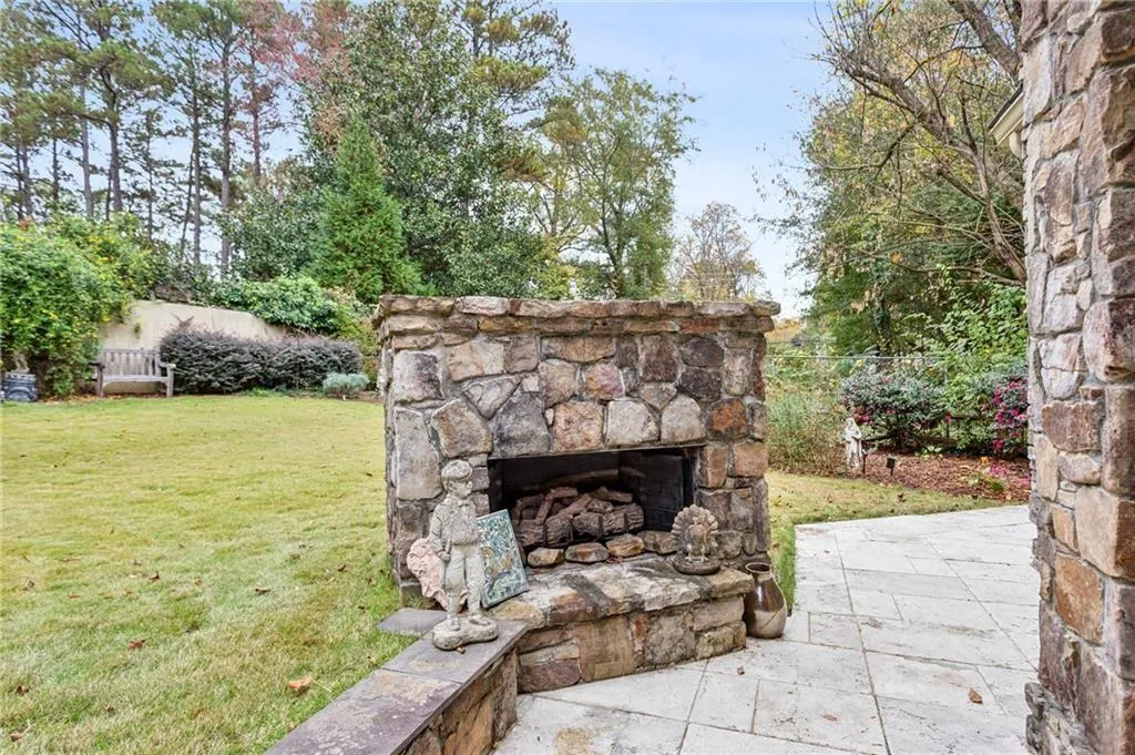 View of patio / terrace featuring an outdoor stone fireplace