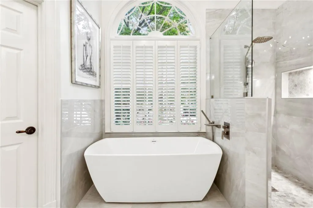 Bathroom with tiled shower and a freestanding bath