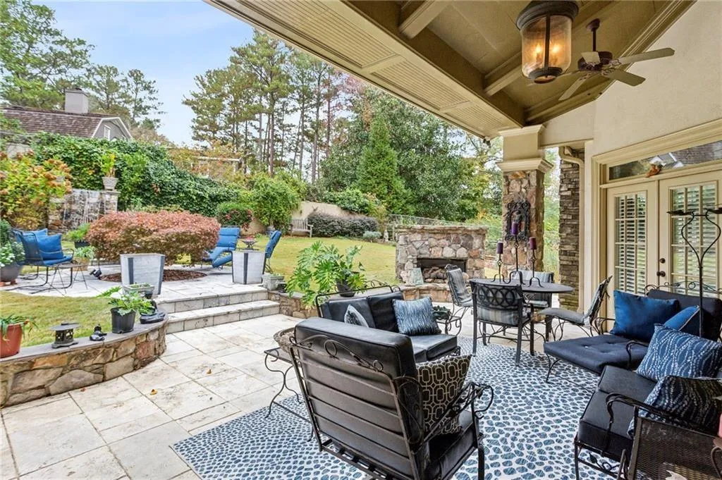 View of patio featuring an outdoor living space with a fireplace and a ceiling fan