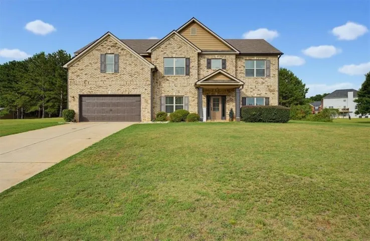 Brick exterior with a prominent two-car garage