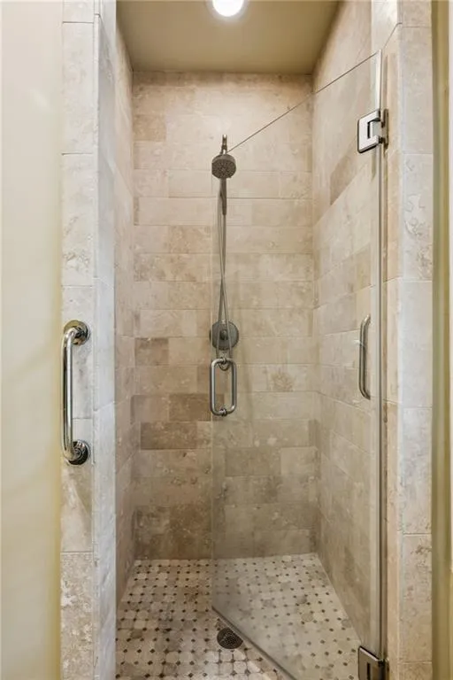 Full bathroom featuring a stall shower