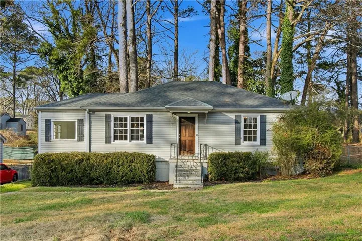 View of front facade featuring roof with shingles