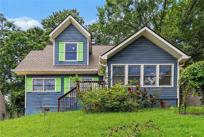 Two-story residence featuring blue horizontal siding and a brown shingle roof