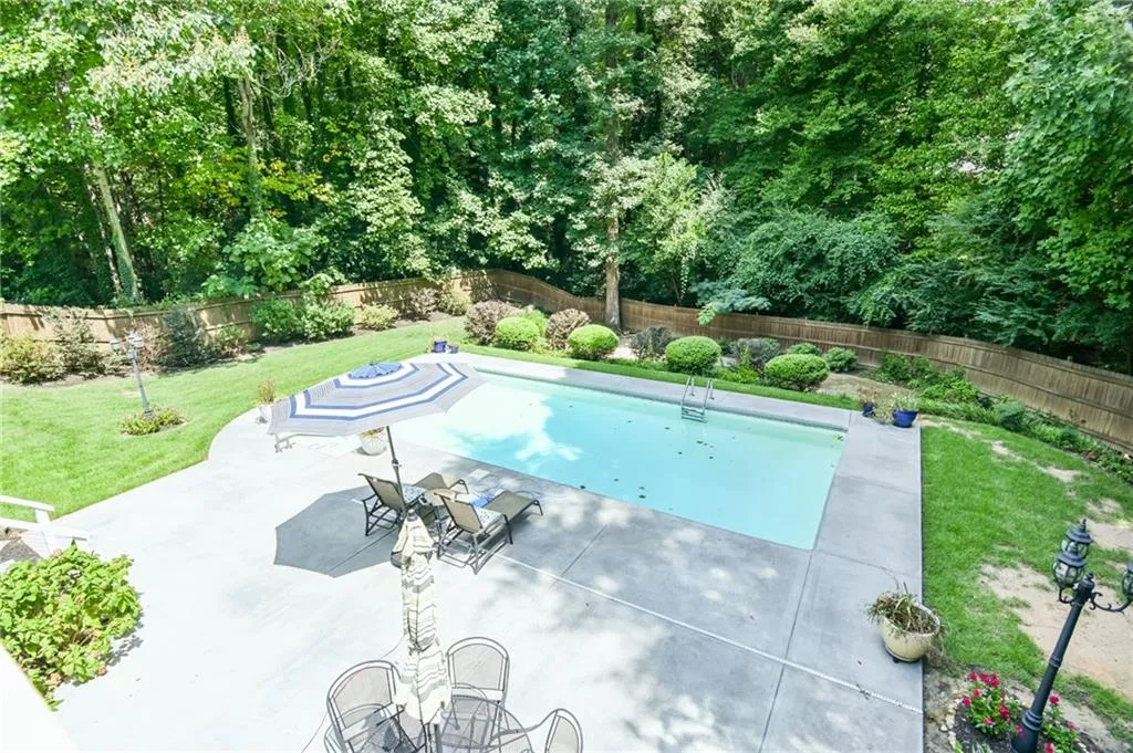 View of pool featuring a yard and a patio area