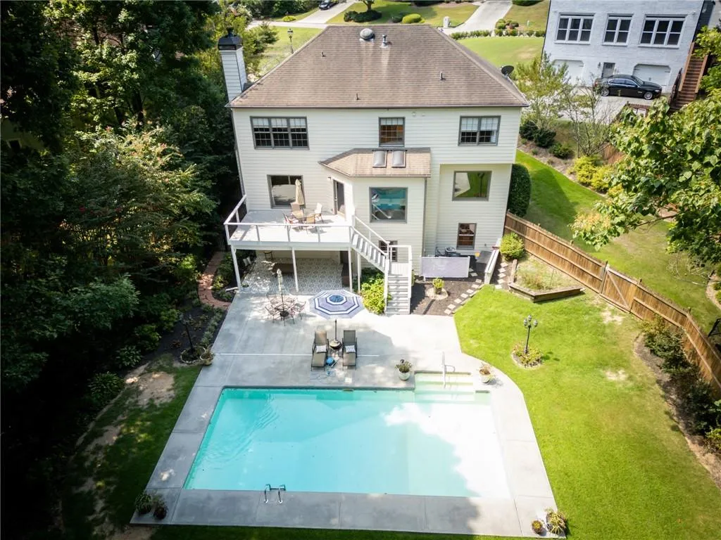 Back of house with a lawn and a patio