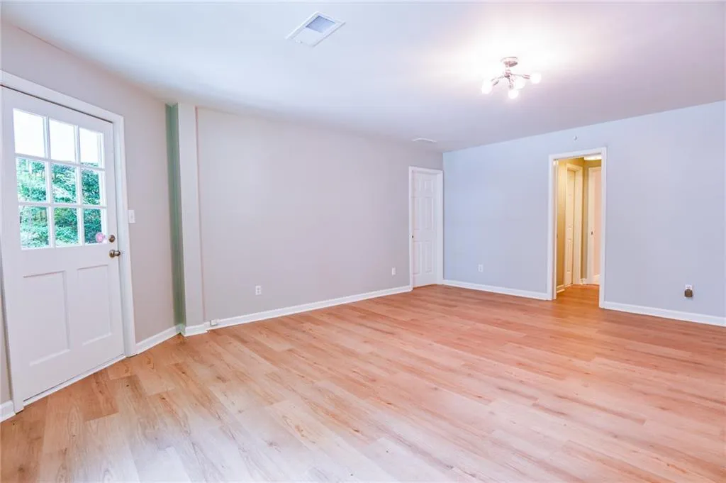 Empty room featuring light wood-type flooring