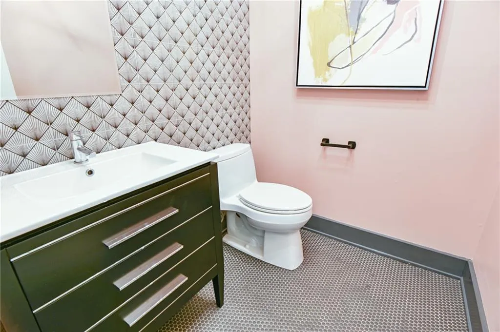 Bathroom with tile patterned flooring, vanity, and toilet