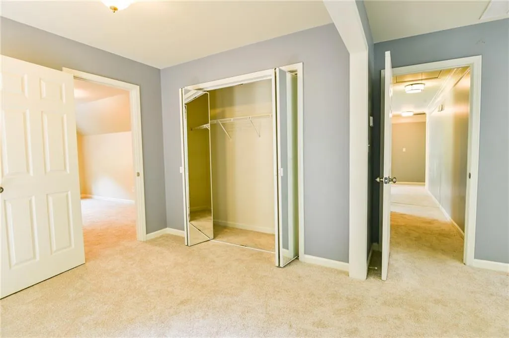 Unfurnished bedroom featuring a closet and light carpet