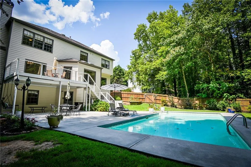 View of swimming pool with a lawn and a patio area
