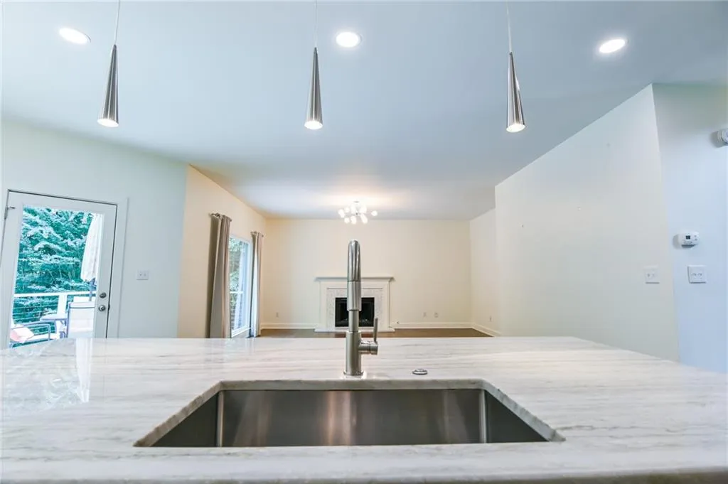 Kitchen with sink and light stone countertops