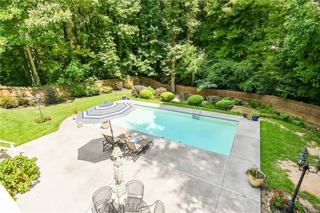 View of pool featuring a yard and a patio