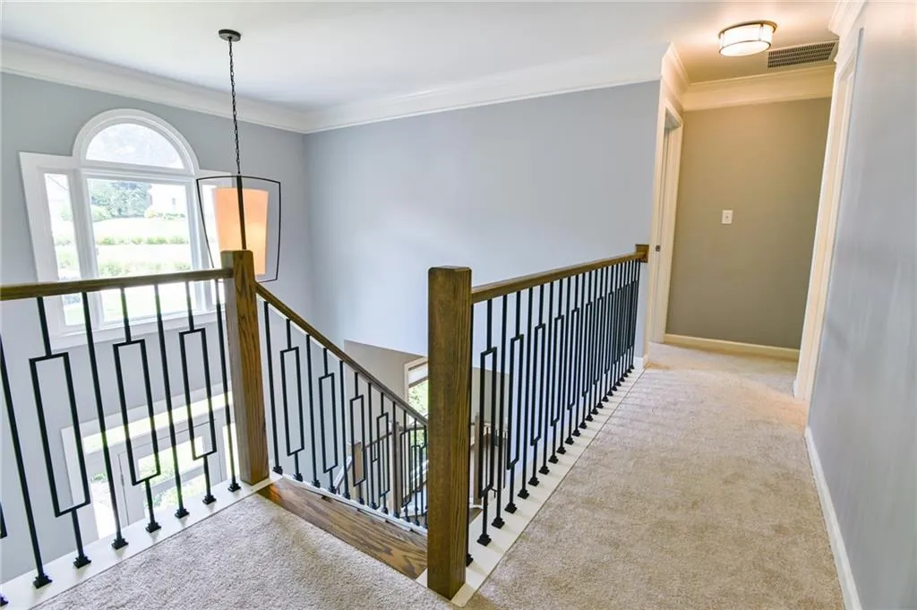 Staircase with carpet and ornamental molding