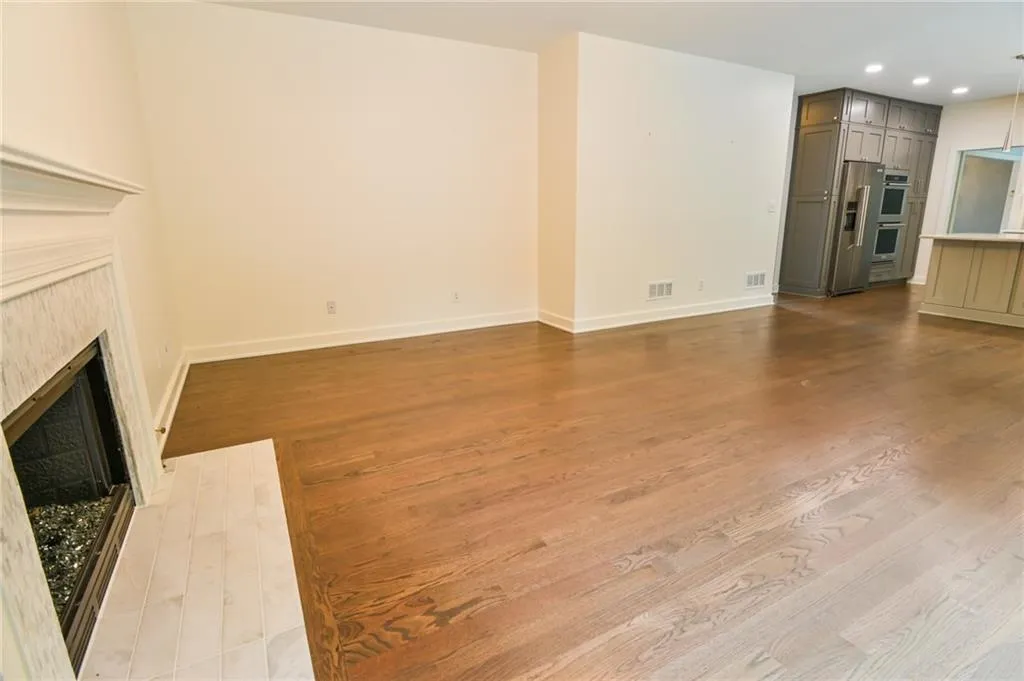 Unfurnished living room featuring hardwood / wood-style floors and a fireplace