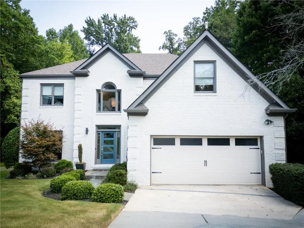 View of front of house featuring a garage and a front yard
