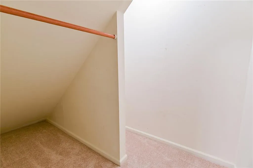 Bonus room featuring light colored carpet