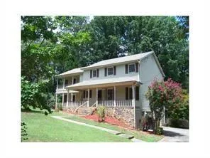 Two-story exterior with stone veneer foundation and neutral siding