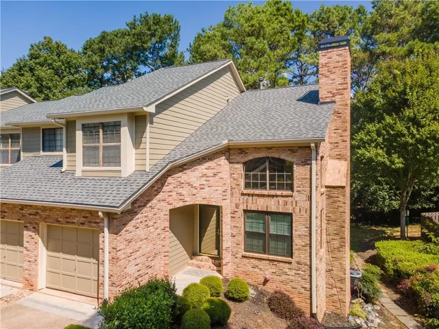 Brick and siding exterior with a prominent brick chimney