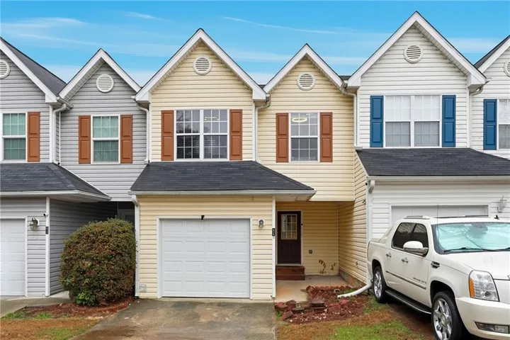 Traditional-style home with an attached garage and concrete driveway