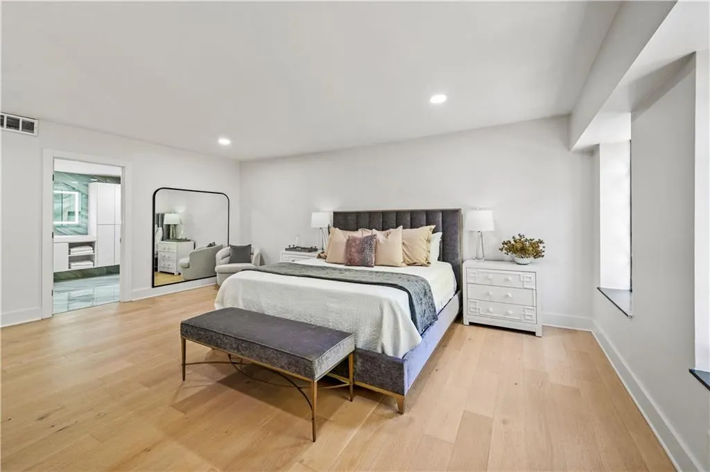 Room featuring wood-finish flooring, recessed lighting, and a window nook
